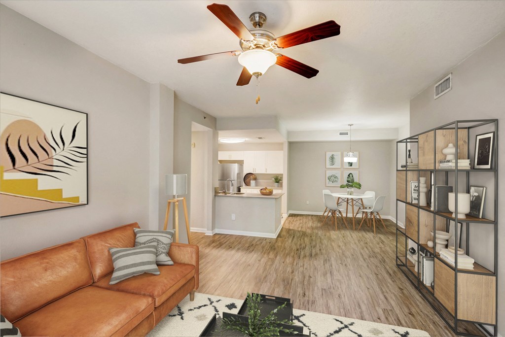 a living room with a couch and a ceiling fan