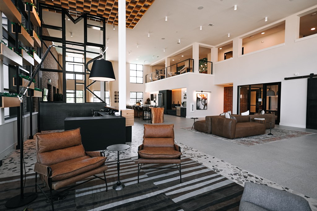 a large lobby with couches and chairs and a fireplace