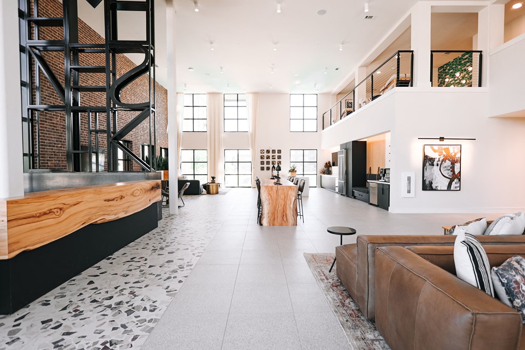 a large living room with a fireplace and a staircase in the middle