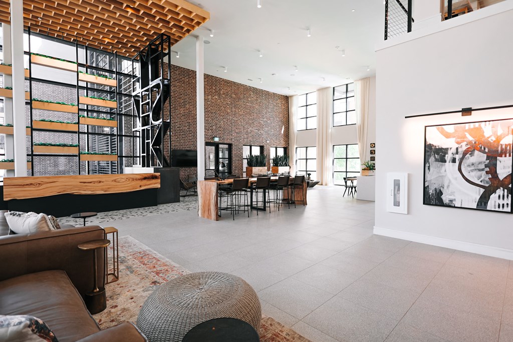 the living room and dining area of a modern house with a large open floor plan