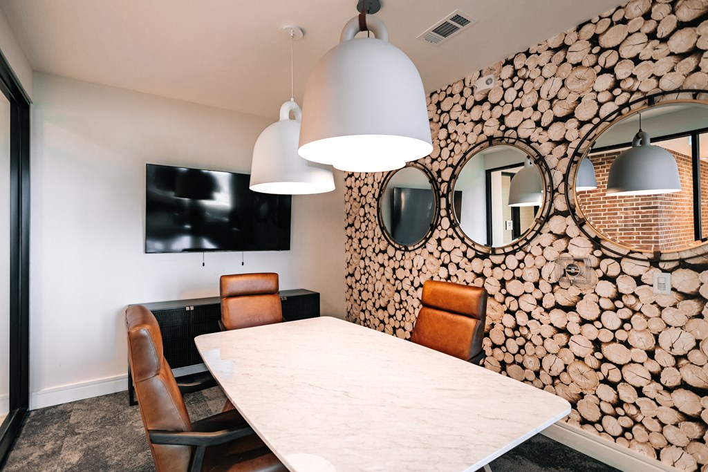 a dining room with a table and chairs and a wall of logs