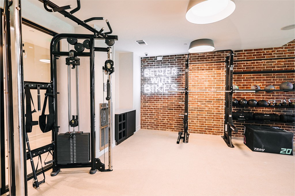 a home gym with a brick wall and exercise equipment