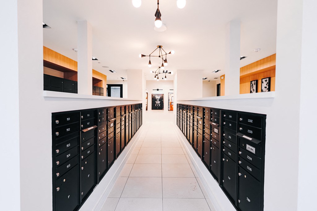 a long corridor with lockers in a room with white ceilings and a white floor