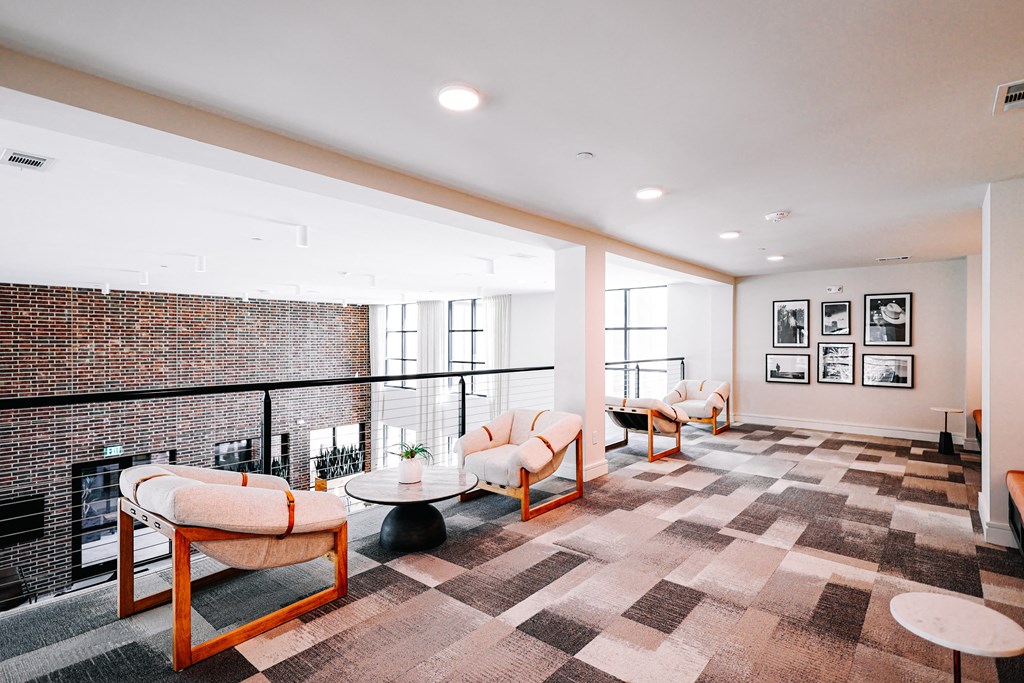 a living room with a brick wall and a balcony
