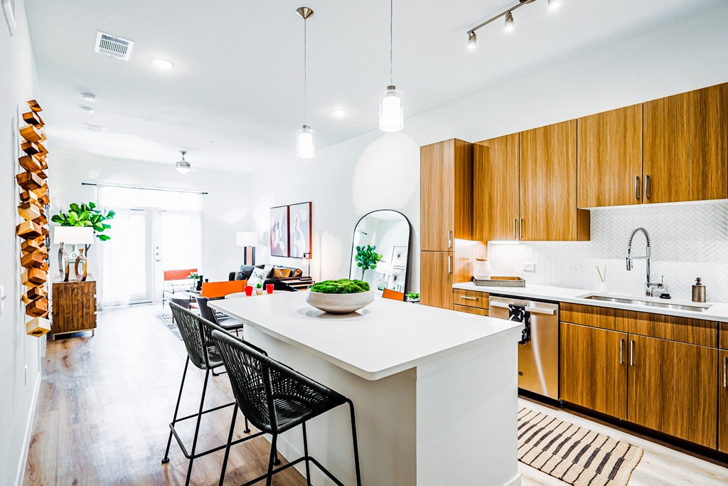 a large kitchen with wooden cabinets and a white counter top