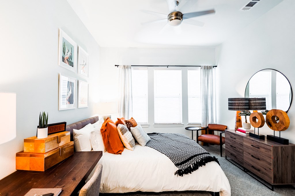 a bedroom with a bed and a large window