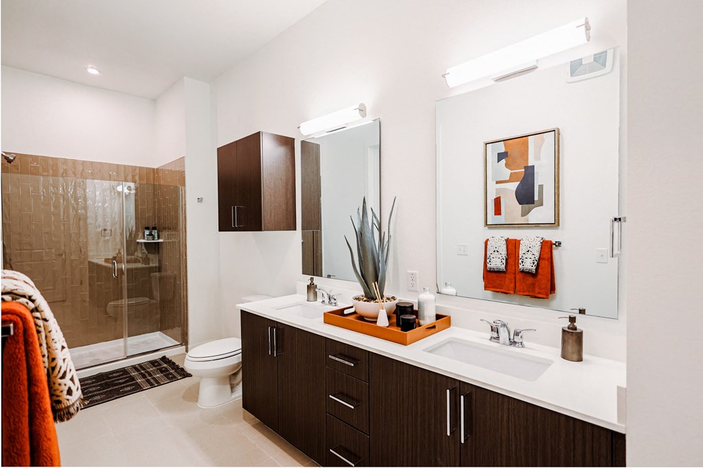 a bathroom with a sink and a shower and a toilet