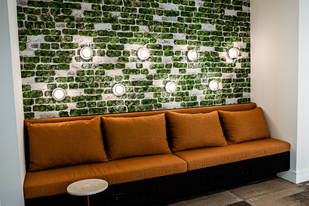 a living room with a couch and a green wall with lights on it