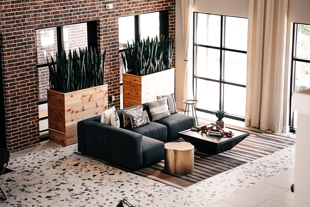 a living room with a black couch and a coffee table
