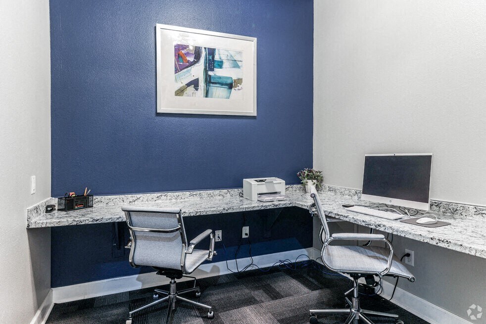 a office with two desks and a computer