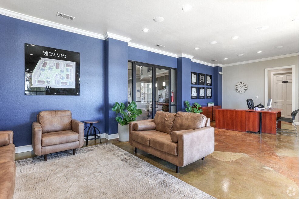 a lobby with couches and a tv on the wall