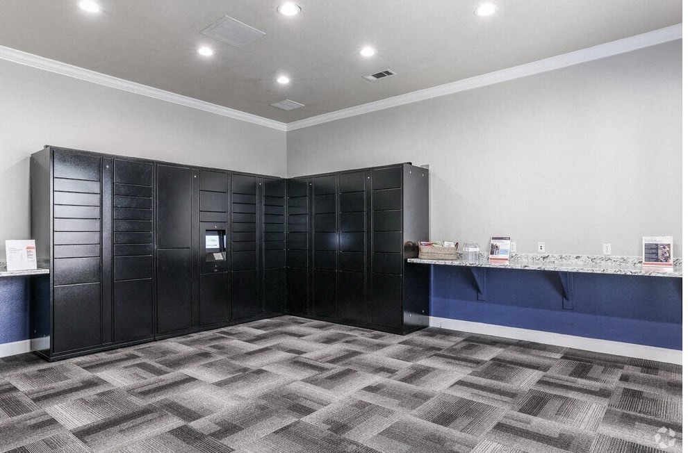 a room with a counter and a lobby with black lockers