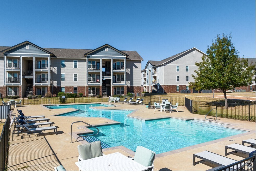 our apartments offer a swimming pool with chairs and tables
