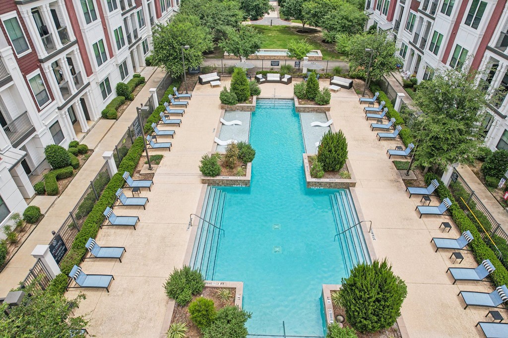 an aerial view of a swimming pool in front of a building