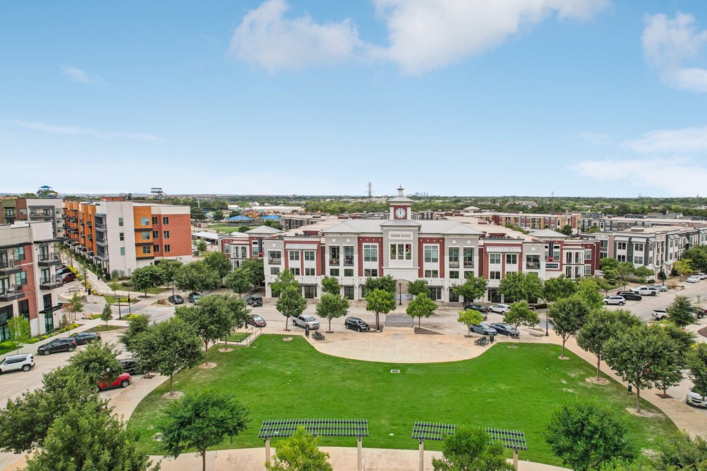 an aerial view of a campus with buildings and a green field
