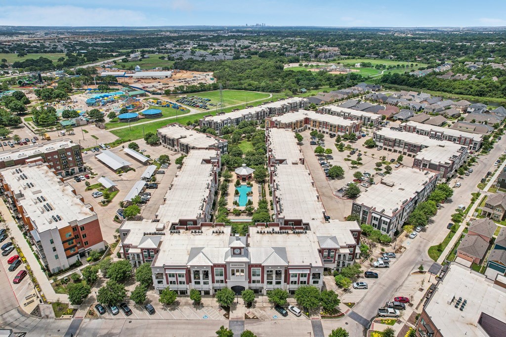 an aerial view of a city with buildings and a pool