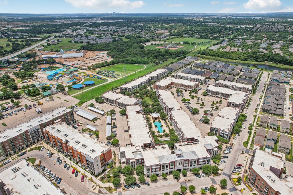an aerial view of a city with buildings and a pool