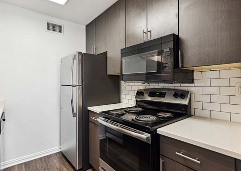a kitchen with a stove microwave and refrigerator