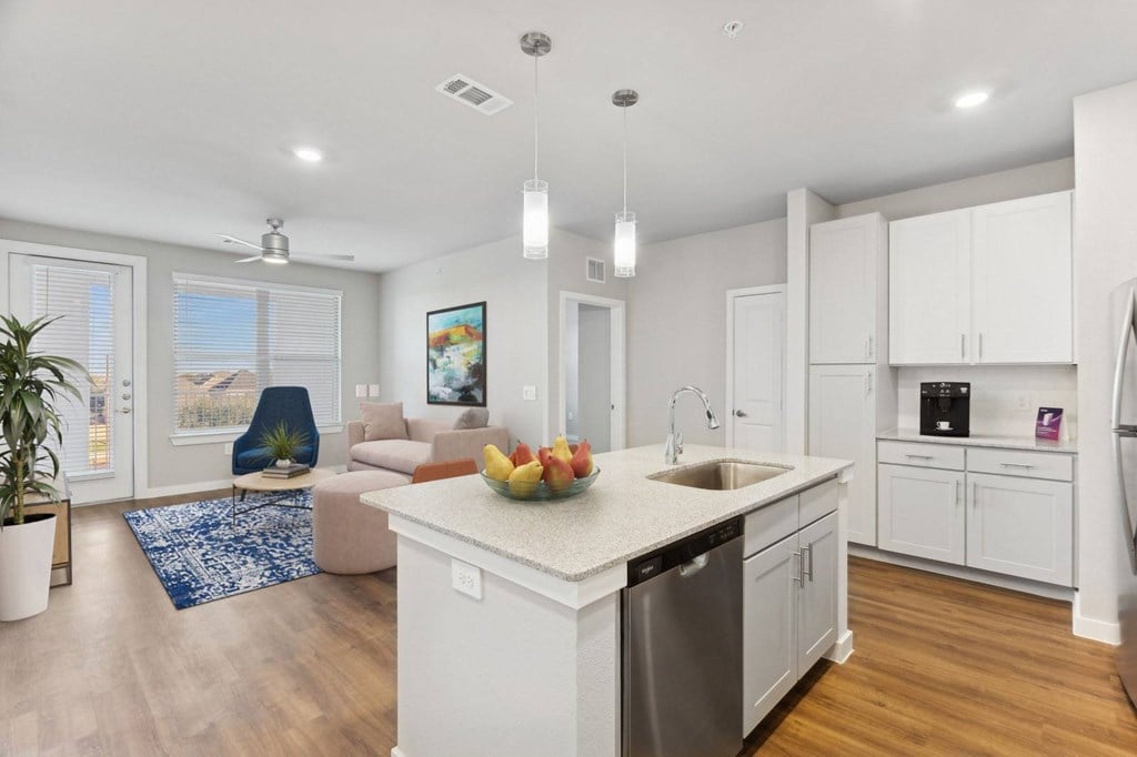 A kitchen with a dining area and a plant.