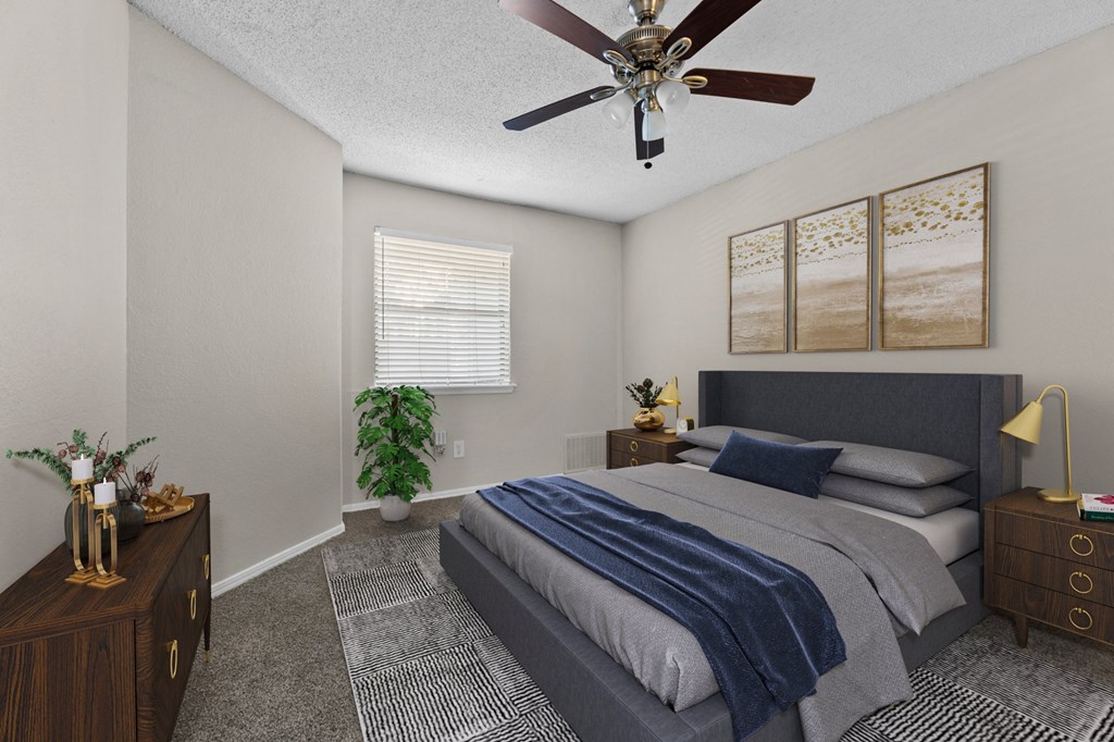 a bedroom with a bed and a ceiling fan