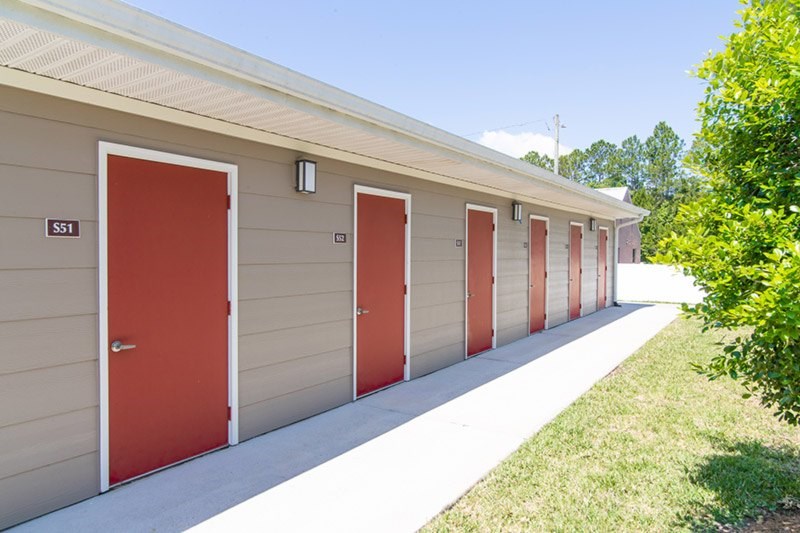 A series of garage doors are lined up on a building.