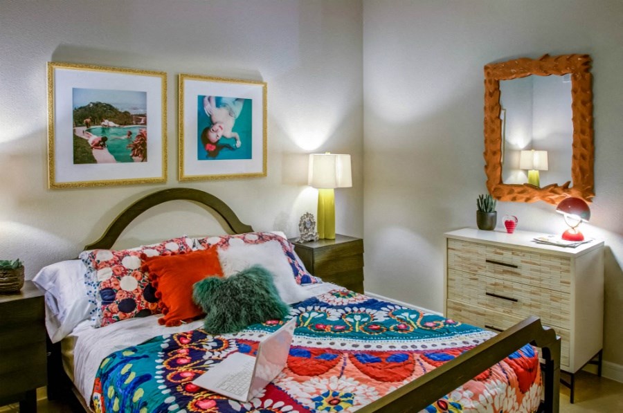 a bedroom with a bed and pictures on the wall