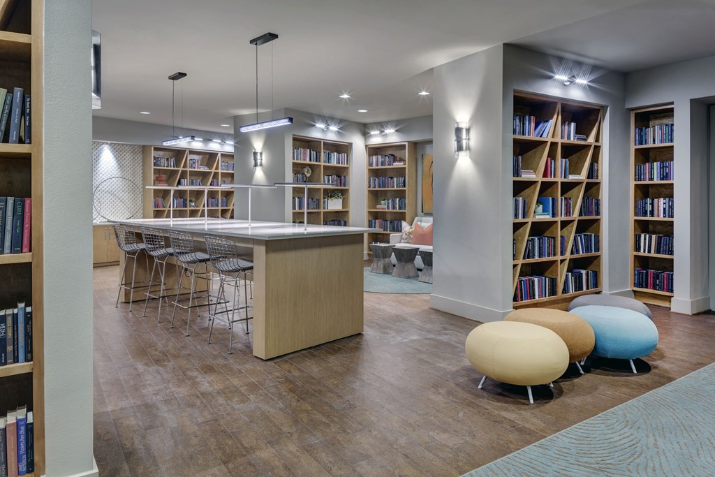 a library with a bar and a table with chairs