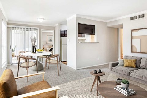 A living room with a grey couch and a wooden coffee table.