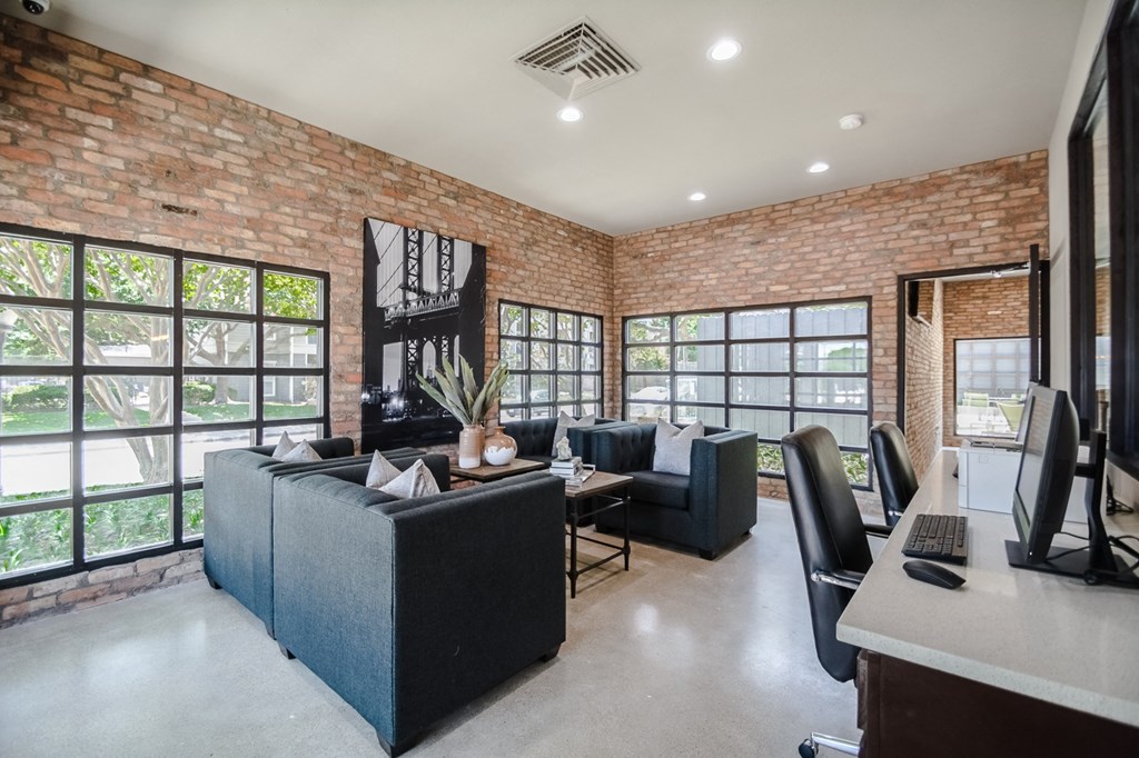 a living room with a brick wall and a large window