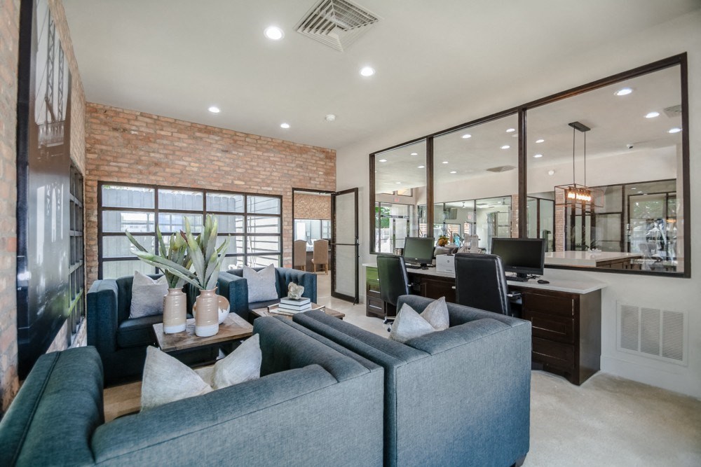 a living room with blue couches and a coffee table