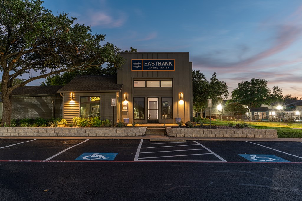 a rendering of the exterior of a building with a parking lot
