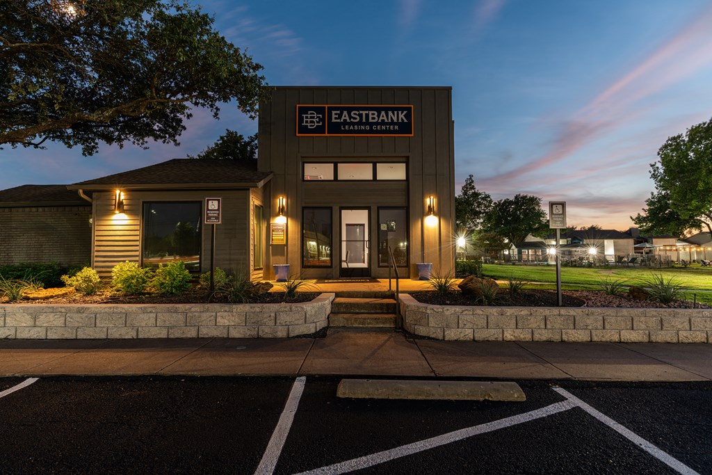 the exterior at night with lights on the building