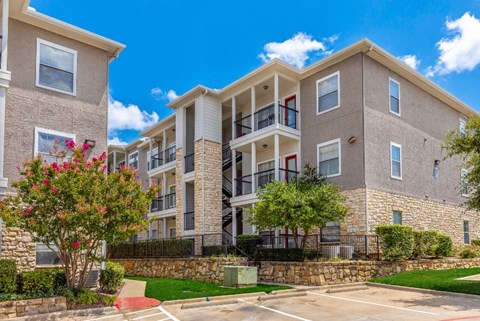 A sunny day at a residential building with a clear blue sky.