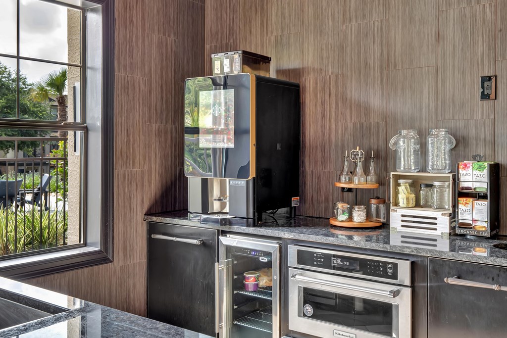 a kitchen with a stove top oven next to a window