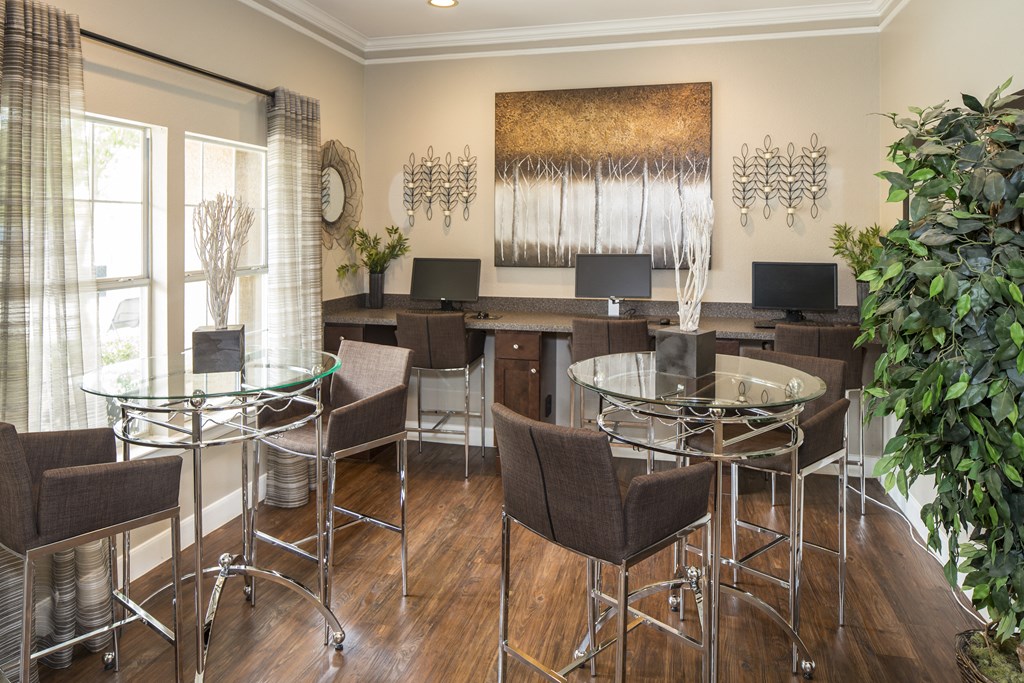 a room with a table and chairs and a painting on the wall
