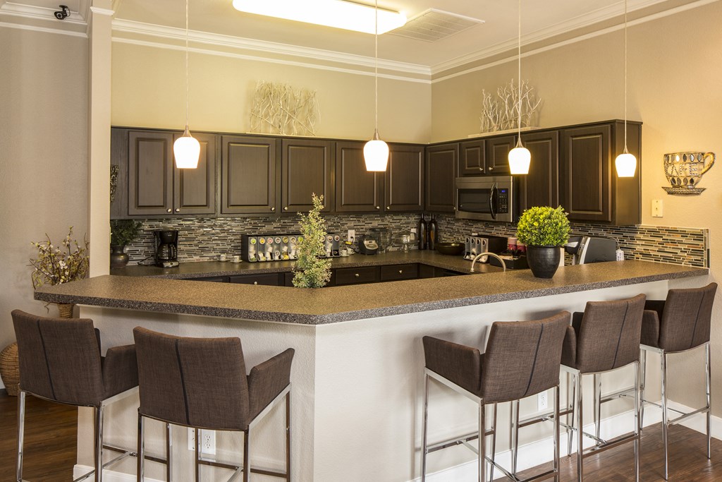 a kitchen with a large island with a breakfast bar
