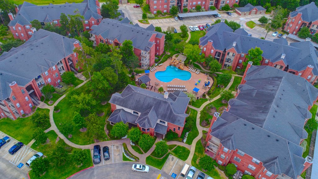 an aerial view of a neighborhood with a swimming pool and parking lot