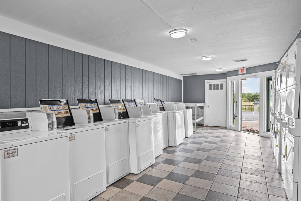 a row of washers and dryers in a laundromat