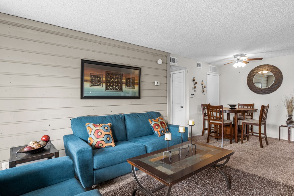 a living room with a blue couch and a coffee table