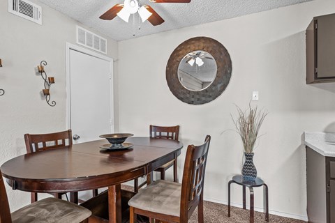 a dining room with a table and chairs