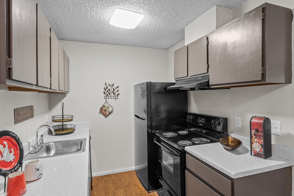 a kitchen with a stove top oven next to a sink