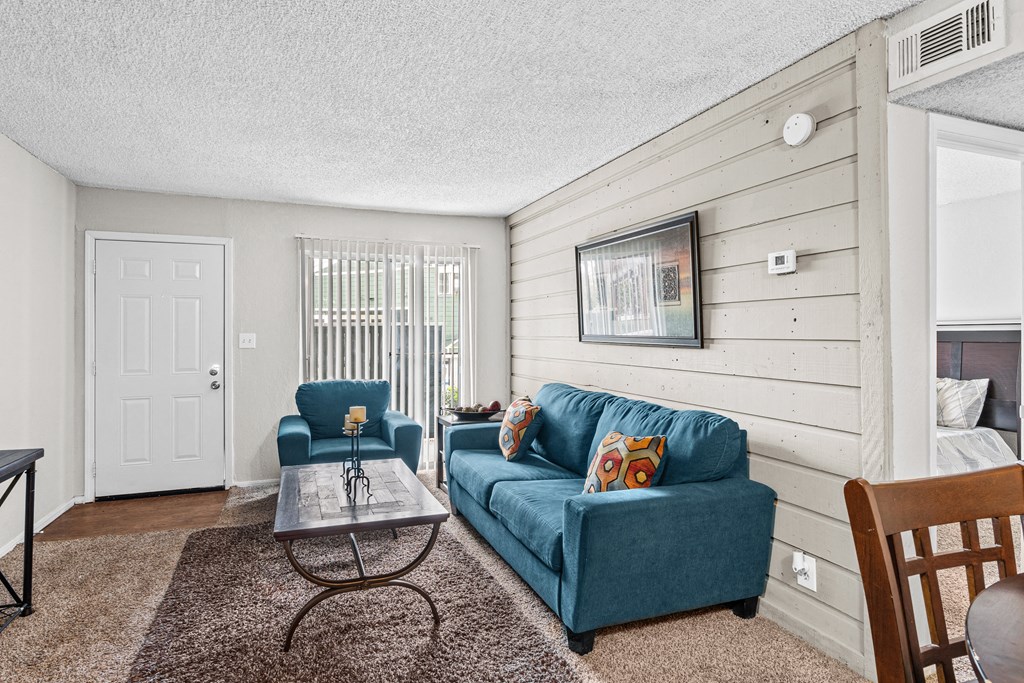 a living room with a blue couch and a coffee table