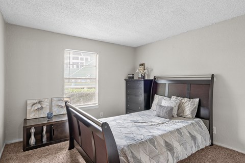 a bedroom with a bed and a dresser