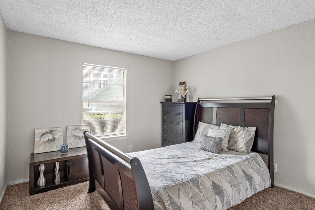 a bedroom with a bed and a dresser