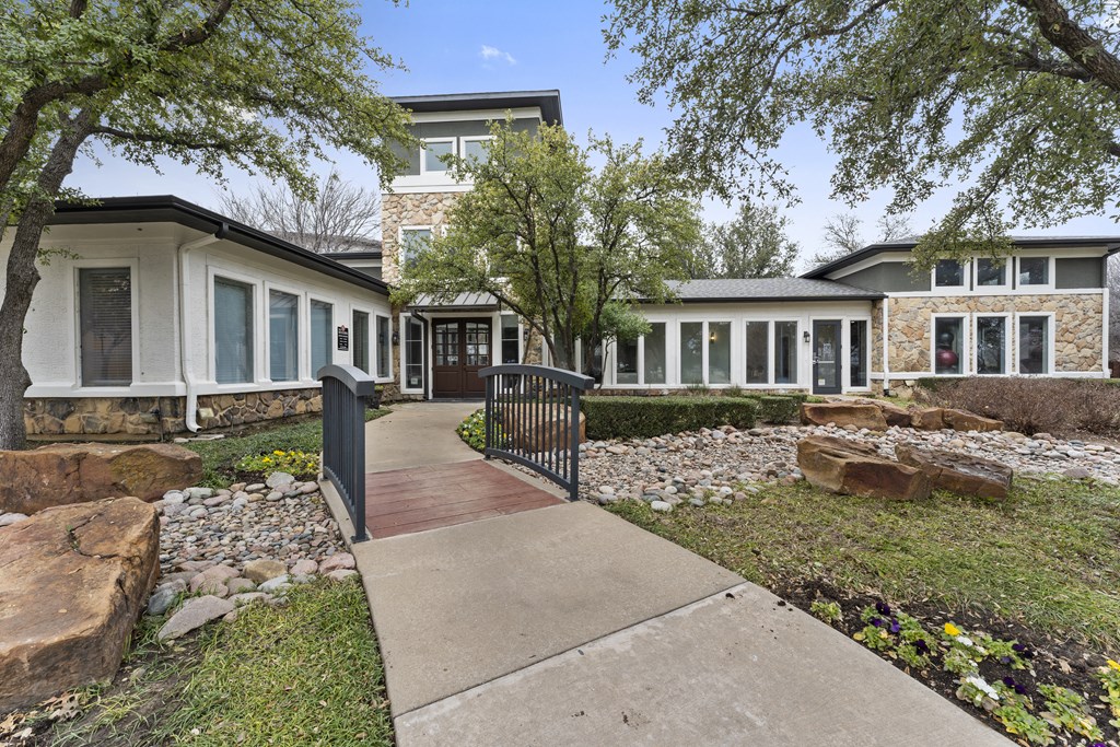 a walkway in front of a house with a gate