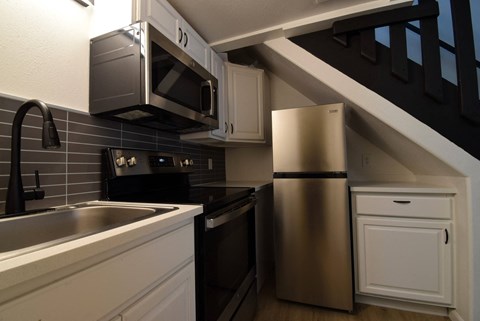 a kitchen with a sink and a refrigerator