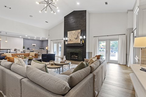 a living room with a large couch and a fireplace