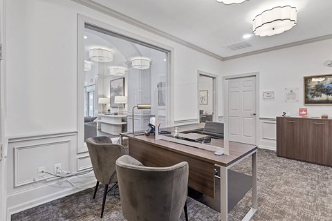 a conference room with a desk and chairs and a mirror
