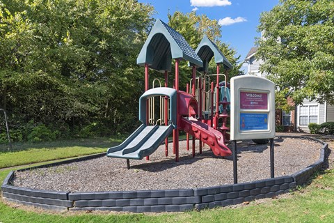 a playground with a red slide and a blue and red