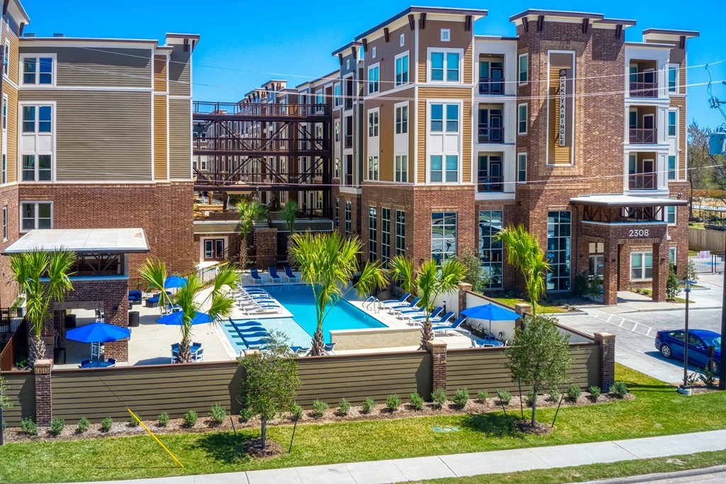 an aerial view of an apartment building with a swimming pool